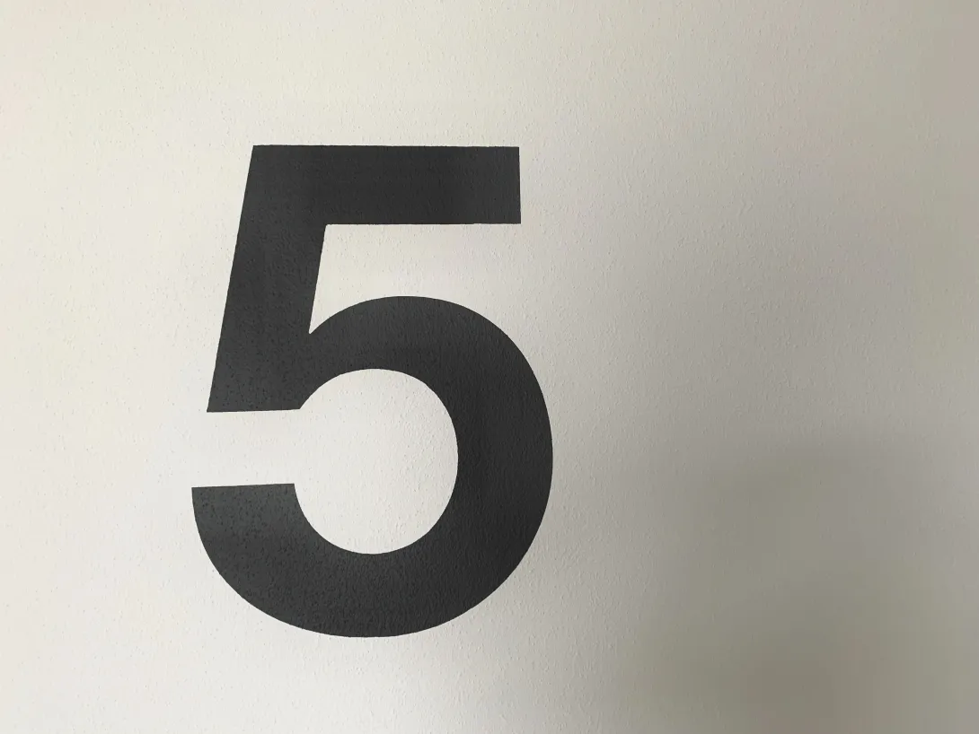 A black number five on a white background