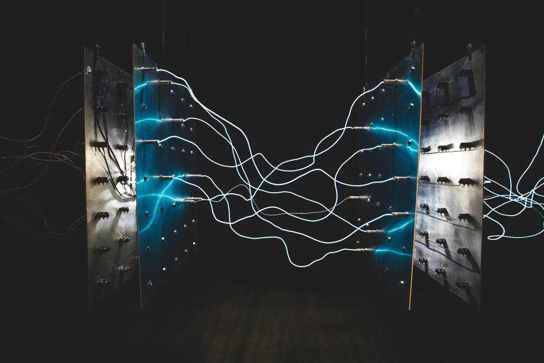 Two metalic panels on the side connected by wires which arc blue at their tips from being not entirely connected